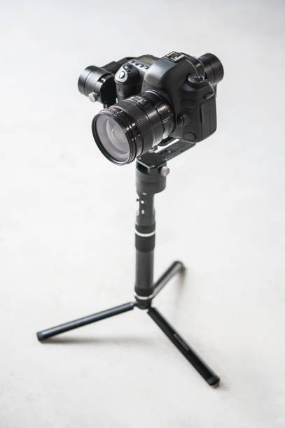 istock Movie camera on tripod. Professional digital equipment recording in studio 1390343437