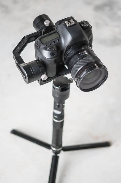 istock Movie camera on tripod. Professional digital equipment recording in studio 1390343511