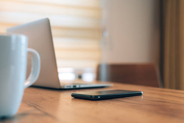 istock Mobile smart phone, laptop computer and coffee cup at home office workspace 1390343838