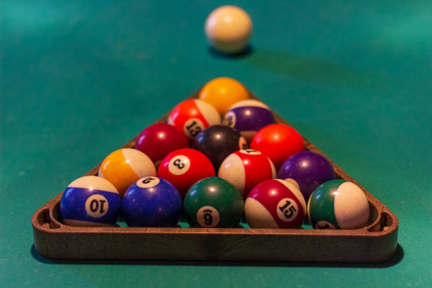 Snooker balls on a pool table in a billiard room for american billiard game. Picture of snooker balls on a pool table in a billiard room for american billiard game. triangle building stock pictures, royalty-free photos & images