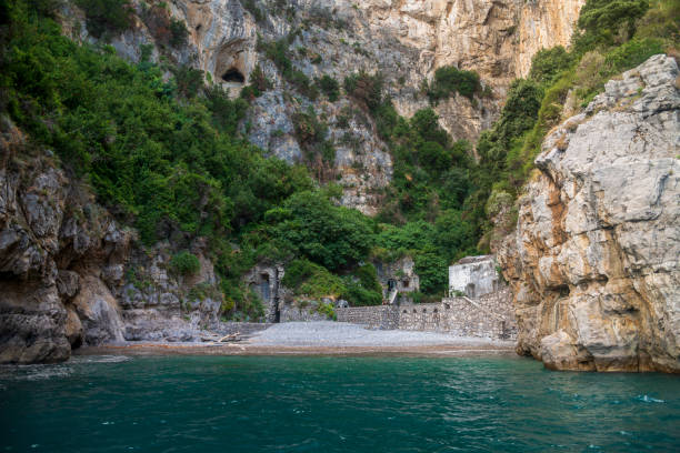 A secluded beach, at the base of a cliff,  on the Amalfi Coast of Italy, between Positano and Amalfi.