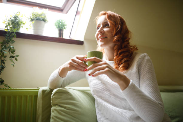istock Contemplating about her day while enjoying a cup of coffee 1390348889