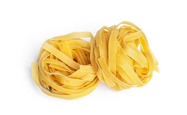 istock Fettuccine pasta isolated on a white background. Pasta nests 1390349237