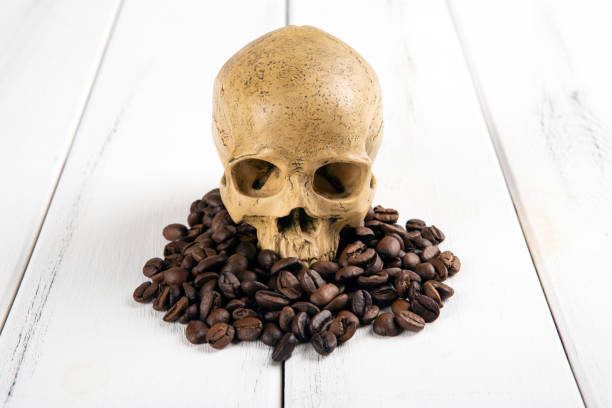 istock roasted coffee beans with a human skull as a symbol of danger 1390352005