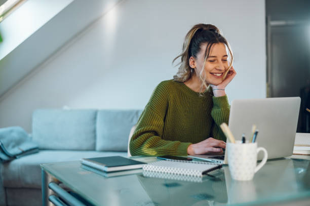 istock Woman working from a home on her a laptop 1390353257