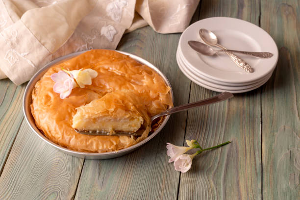 istock Milk pie with sauce on a wooden table 1390353283