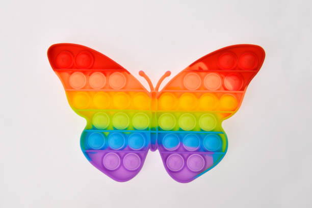 istock Pop it silicone rainbow anti-stress toy isolated on white background. Simple dimple. 1390353363