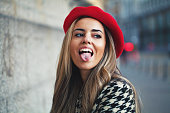 Young woman sticking out tongue