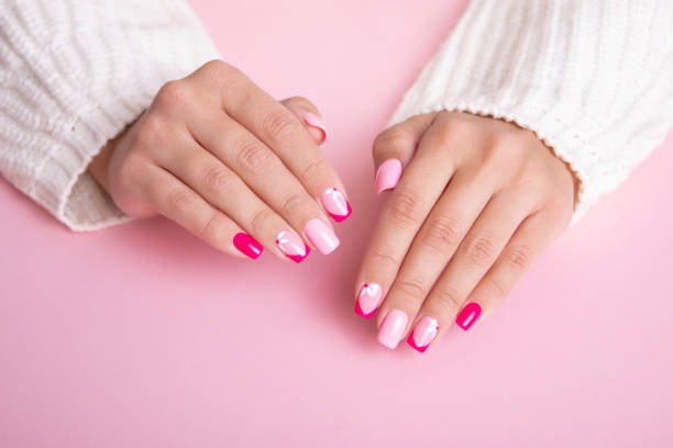 istock Female hands with pink manicure nails 1390362001
