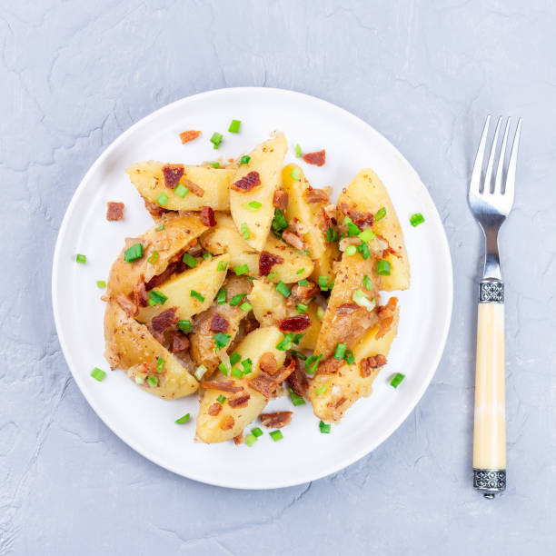 istock Bacon and onion potato salad dressed with apple cider vinegar and mustard, on plate, square 1390362821