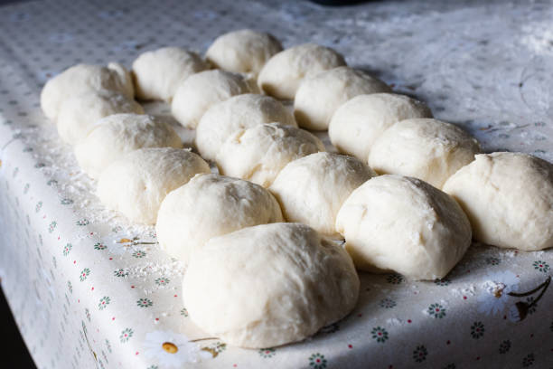 istock Balls from the dough for pies on the kitchen table. Baking at home. Selective focus. 1390362835