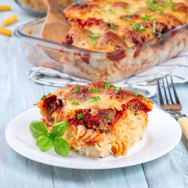 istock Mac and cheese with meatballs, mozzarella, tomato sauce and basil, on white plate, square format 1390362912