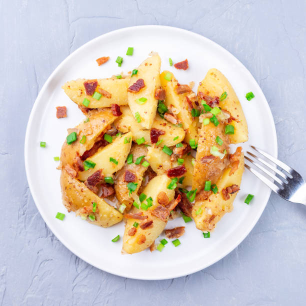 istock Bacon and onion potato salad with apple cider vinegar and mustard, on plate, square format 1390362946