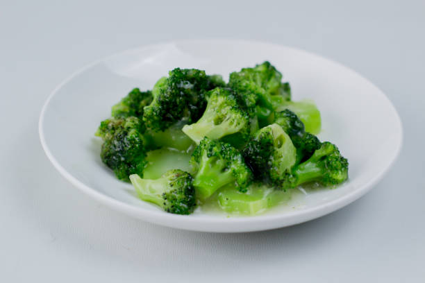 Green broccoli vegetable salad. Good for dieting. Green broccoli vegetable salad. Good for dieting. Served on a plain white plate. brokoli stock pictures, royalty-free photos & images