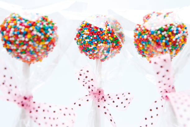 Delicious chocolate cake pop and icing dipped in a milk chocolaty coating and covered with multi-colored sprinkles.