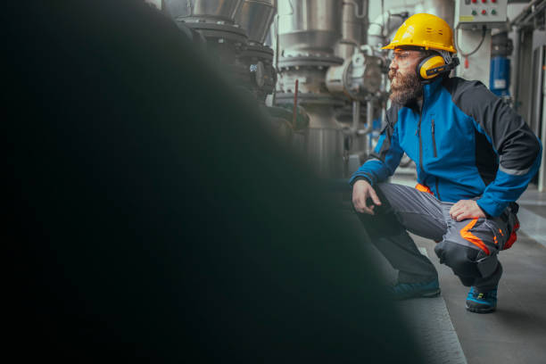 istock A heating plant worker carrying antiphons checks the machines. 1390378310