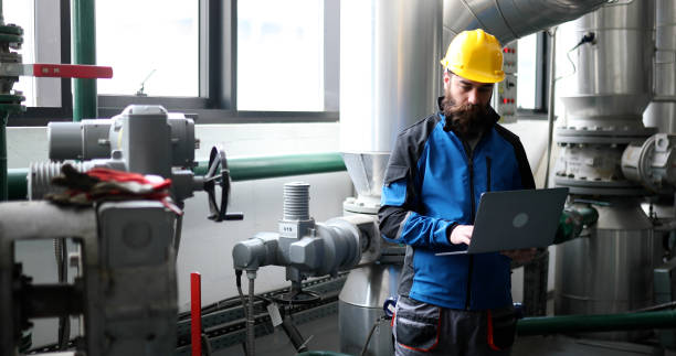 istock The heating plant worker uses a laptop when working inside the heating plant. 1390378312