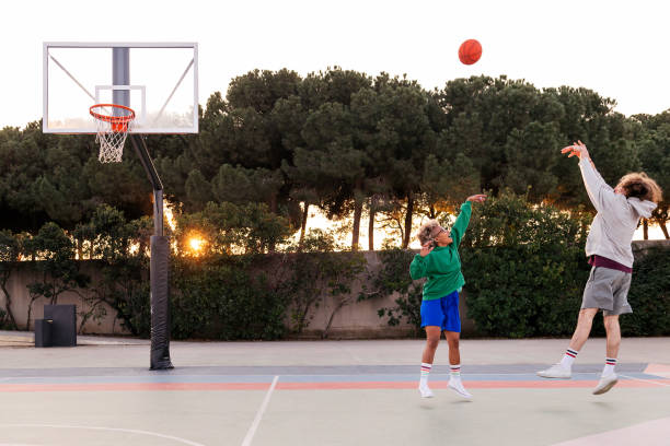 istock latin woman playing basket with a caucasian man 1390378433