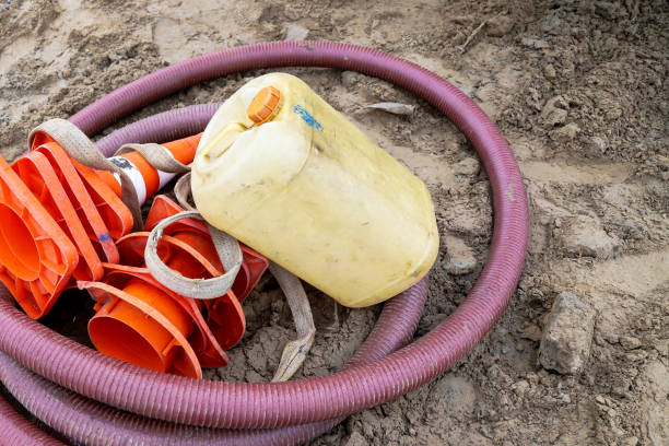istock Construction hose, water canister and orange cones are on the ground again 1390378514
