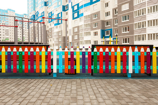 a fence made of pencils in the yard for children to study