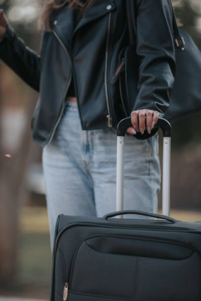 istock Woman traveling with her suitcase in an open environment. 1390382248