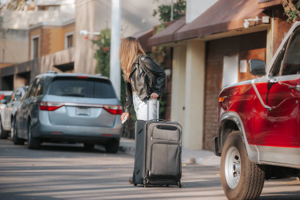 istock Woman traveling with her suitcase in an open environment. 1390382277