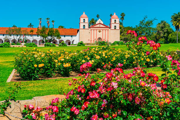 mission santa barbara with a grassy lawn filled with roses - mission santa barbara imagens e fotografias de stock
