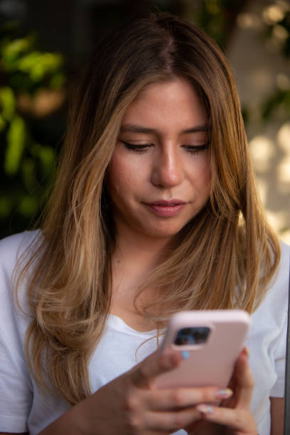 istock Woman using her mobile device in an outdoor environment. 1390384660