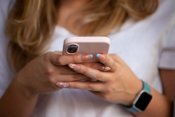 istock Woman using her mobile device in an outdoor environment. 1390384663