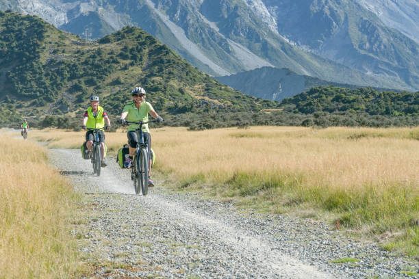 istock Three adults on off road cycle trail 1390387796