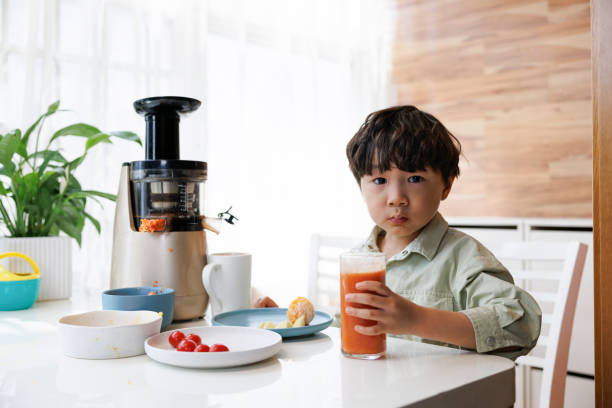 istock Little asian boys drink their own juice 1390387924