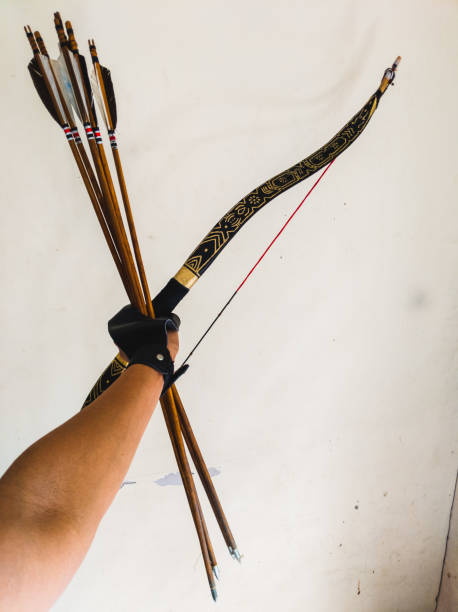 istock holding a bow and arrow with one hand 1390389498