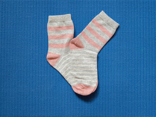 istock Little girl's socks on Blue Background 1390392239