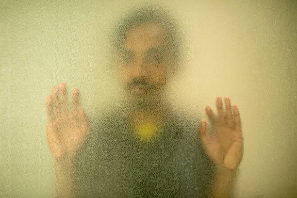 istock Close-Up Of Hand On Glass Window 1390403995