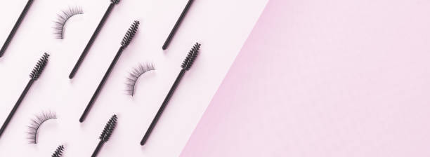 istock Overhead eyelashes and brushes on pink background. Banner. 1390404267