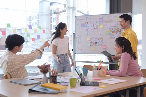 istock Group of young businesspeople brainstorming and discussing ideas for new startup project together at creative office. 1390407621