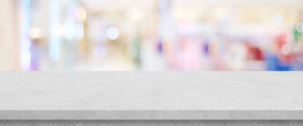 istock Empty white cement table over blur store background, product display montage, black and white tone, monochrome 1390409458