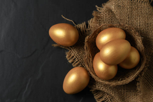 istock Golden easter eggs in nest bird on black 1390414295