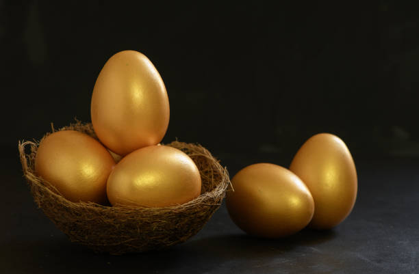 istock Golden easter eggs on nest bird and on black 1390414357