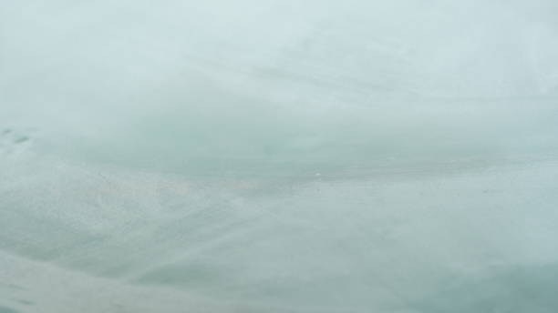 istock Foggy car window. Rain drops outside the window. Abstract 1390416614