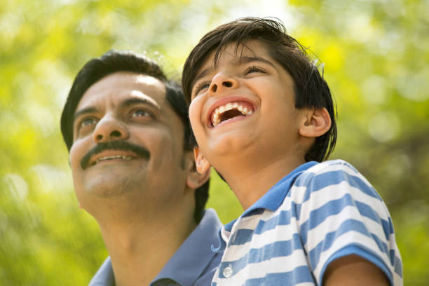 istock Happy father and son admiring view at park 1390417359