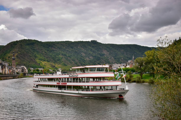 Cochem, Germany - August 26, 2021:. Tourist boat excursion cruise on the Moselle on a cloudy day, Cochem, Germany