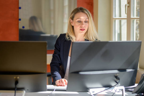istock Businesswoman working in a modern open plan office 1390418893