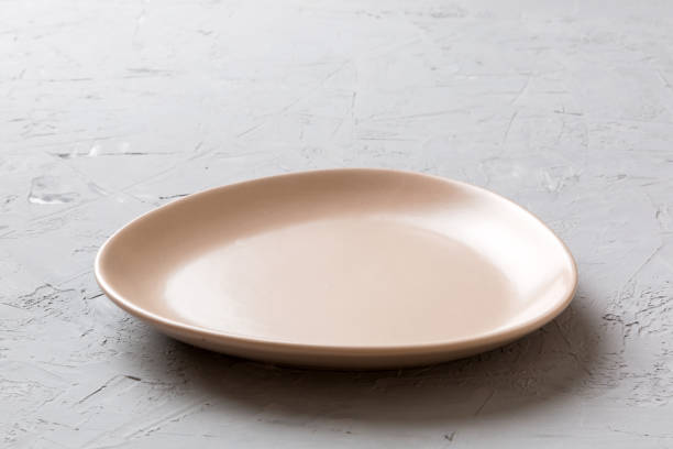 istock Perspective view of empty pink plate on cement background. Empty space for your design 1390419889