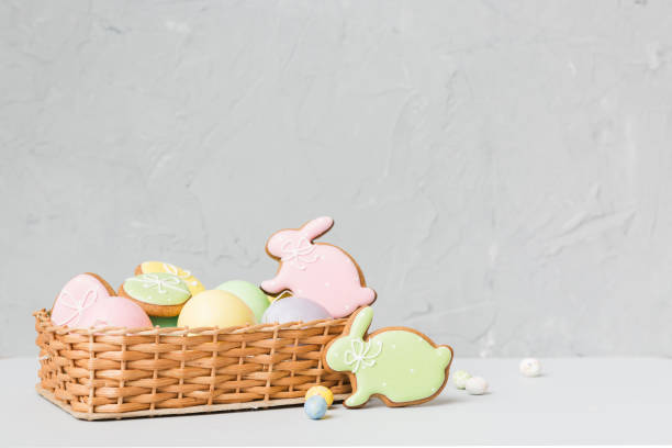 istock Colorful easter cookies in basket with Multi colors Easter eggs on colored background . Pastel color Easter eggs. holiday concept with copy space 1390419902