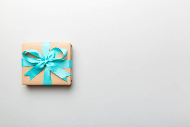 istock Holiday present box over colored background, top view. Copy space for design 1390419925