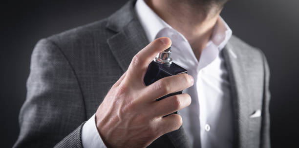 istock Caucasian elegant man spraying perfume. 1390422329