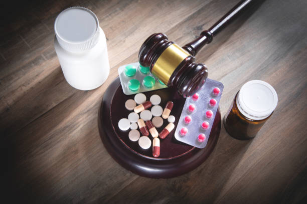 istock Judge gavel with pills on the wooden table. 1390422332