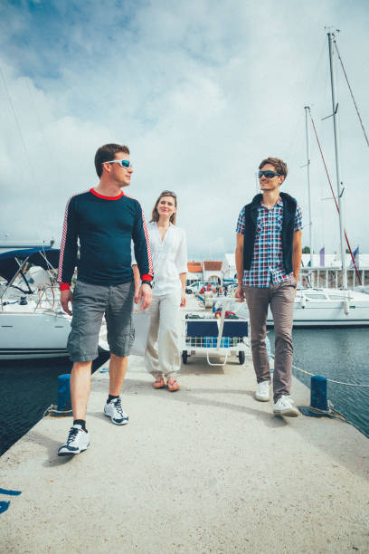 istock Young couple arriving to marina for sailing 1390423636