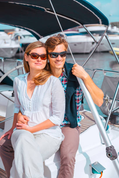istock Young couple sailing on sailboat 1390423683